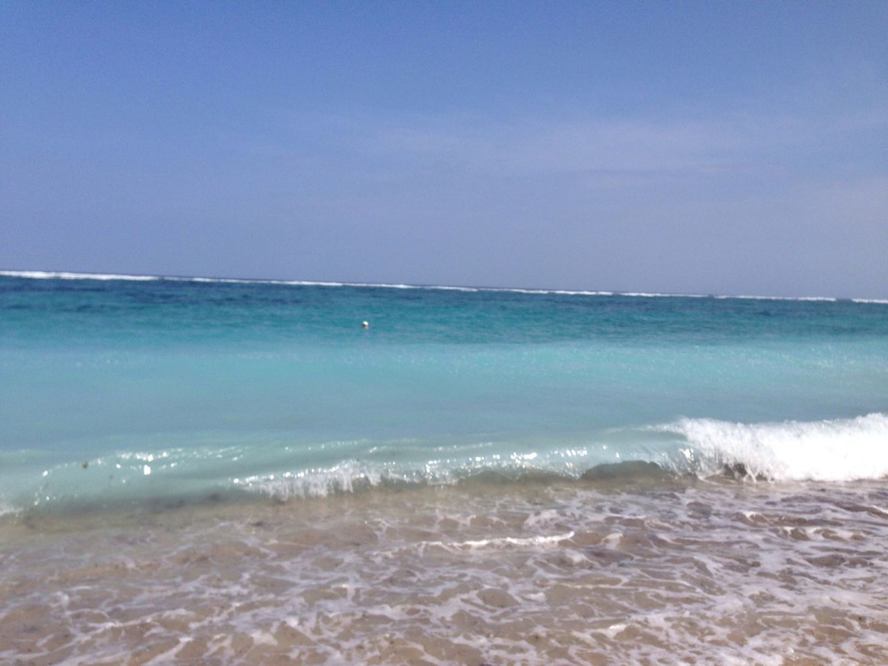 sea, water, horizon over water, beach, wave, surf, shore, scenics, beauty in nature, sand, tranquil scene, tranquility, nature, blue, sky, motion, clear sky, idyllic, coastline, copy space