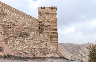 Old ruins of building against cloudy sky