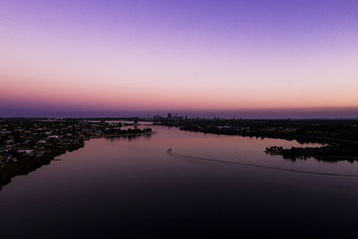 Scenic view of sea against clear sky at sunset