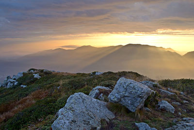 Scenic view of rocky mountains against sky during sunset