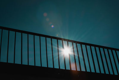 Low angle view of illuminated sun against sky