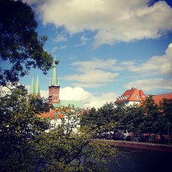 Buildings against cloudy sky