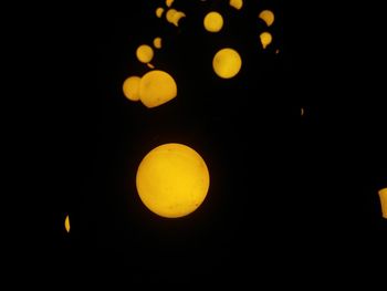 Close-up of yellow moon at night