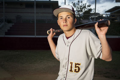 Portrait of high school baseball player holding his bat