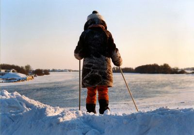 People standing on snow covered field