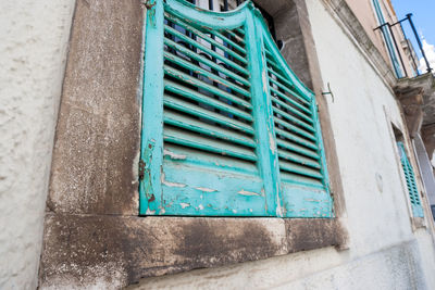 Low angle view of window on wall of building