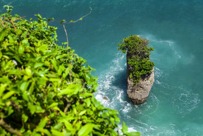 Rock sea and wave at pura uluwatu temple, bali, indonesia