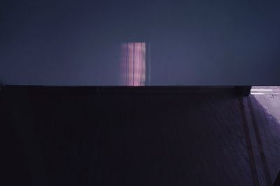 Low angle view of illuminated building against clear sky