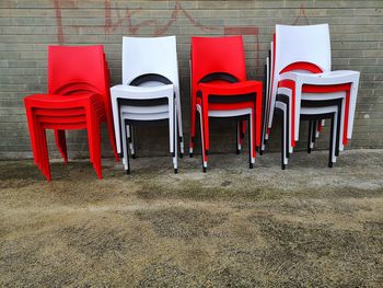 Colorful plastic chairs stacked outside