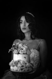 Portrait of a beautiful young woman holding flower