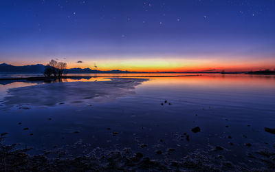 Scenic view of sea against romantic sky at sunset