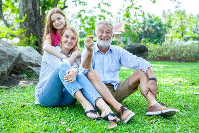 Portrait of smiling family on field