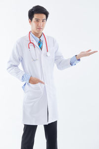 Young man standing against white background