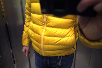 Close-up of man standing on yellow fabric