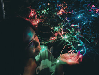 Close-up of illuminated woman