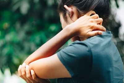 Close-up of hands making face outdoors