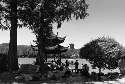 People at temple against clear sky