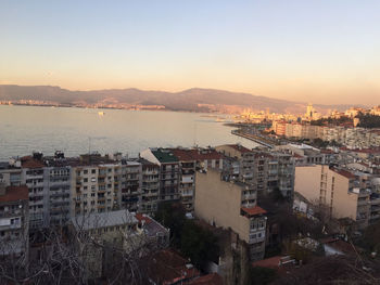 High angle view of townscape by river against sky