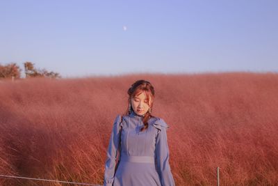 Woman standing on land against sky