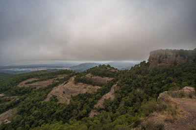 Scenic view of sea and mountains against sky