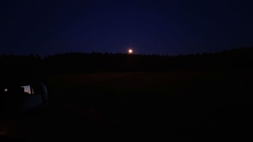 Illuminated car against sky at night