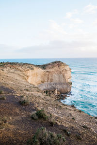 Scenic view of rocks on beach against sky