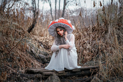 Full length of woman wearing hat in forest