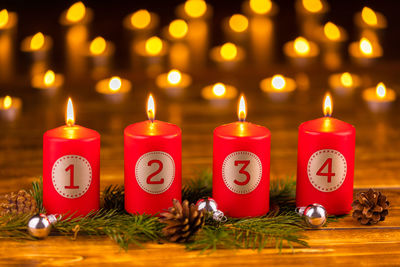 Close-up of lit candles on christmas lights