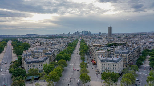 High angle view of city street against cloudy sky