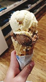 Close-up of hand holding ice cream cone
