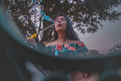 Young woman with bubbles in water