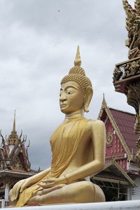 Statue of temple against building