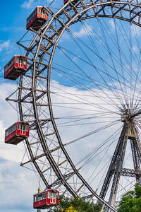 Low angle view of ferris wheel against sky