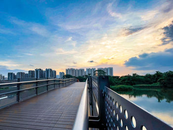 Footbridge over river against sky