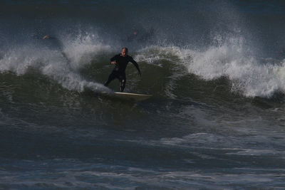 Full length of man surfing in sea