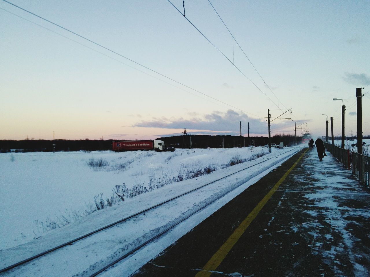 cold temperature, winter, snow, transportation, weather, rail transportation, railroad track, cable, nature, sky, outdoors, frozen, public transportation, sunset, no people, day, beauty in nature