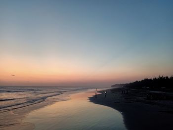 Scenic view of beach against sky during sunset