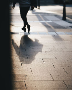 Low section of people walking on street