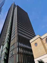 Low angle view of skyscraper against clear blue sky