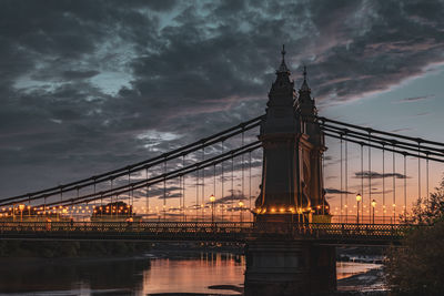 View of bridge over river at sunset