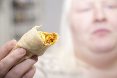 Close-up of woman hand holding food