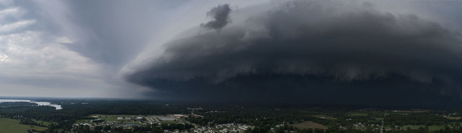Panoramic view of city buildings against storm clouds