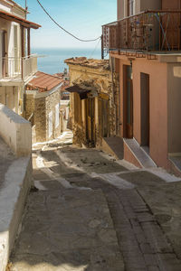 Street amidst buildings in town against sky