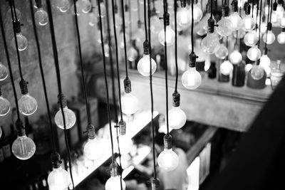 High angle view of illuminated light bulbs hanging at nightclub