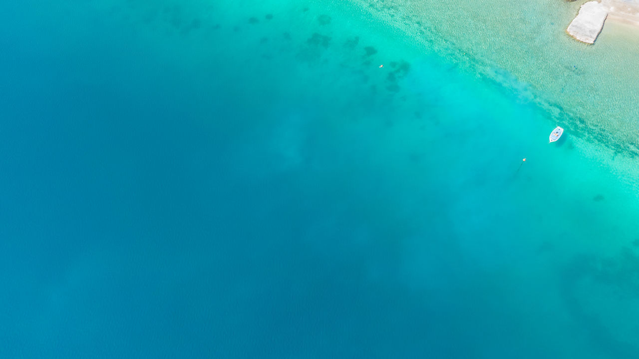 HIGH ANGLE VIEW OF PERSON SWIMMING POOL IN SEA