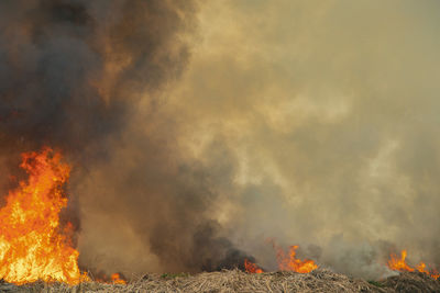 Low angle view of fire against clouds