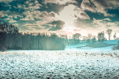 Scenic view of snow covered land against sky