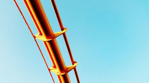 Low angle view of metallic structure against blue sky