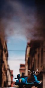 Close-up of vintage car against cloudy sky