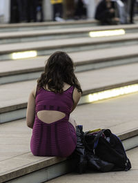 Rear view of woman at railroad station